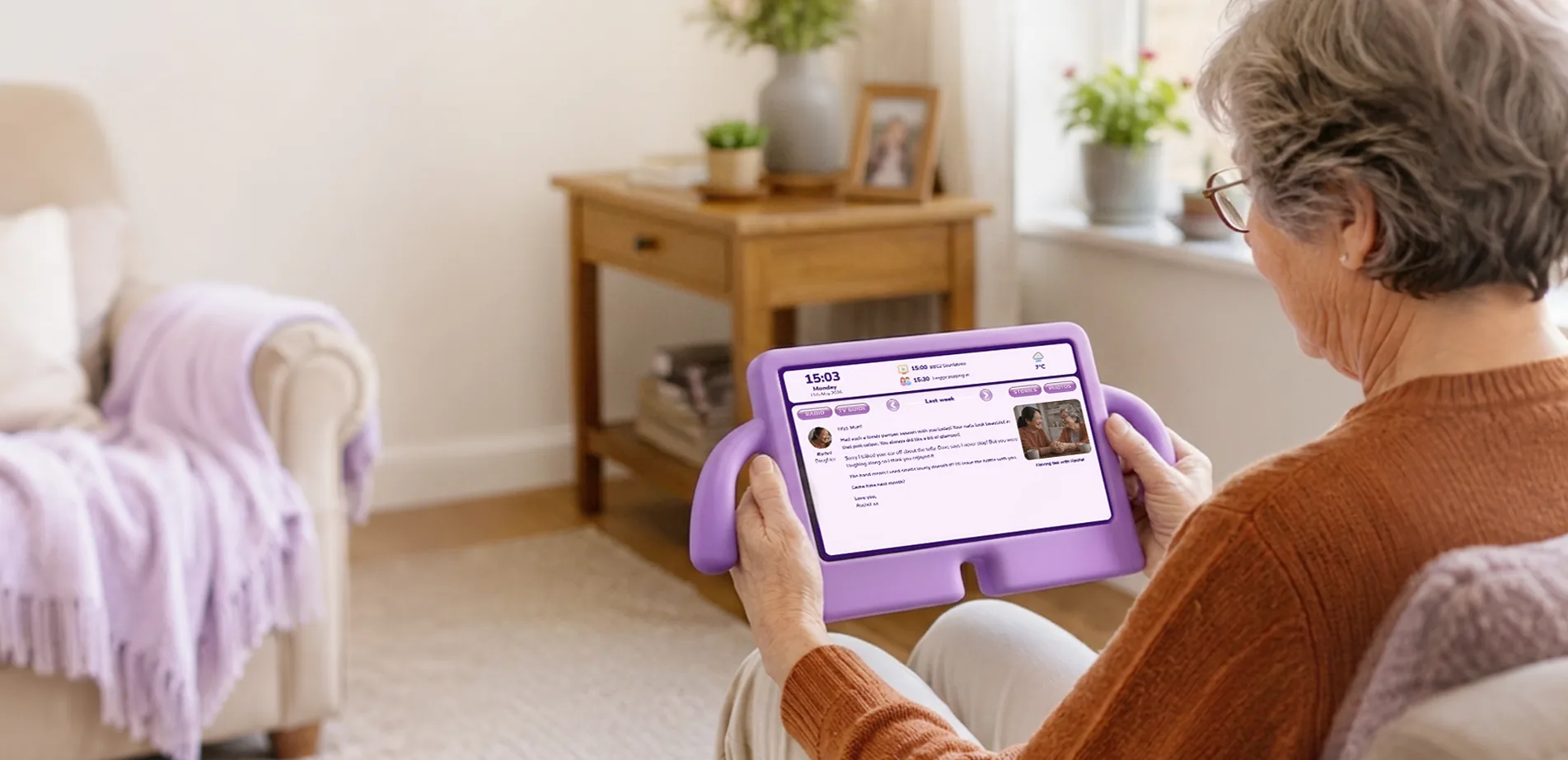 An older lady reading family messages on her nellie tablet