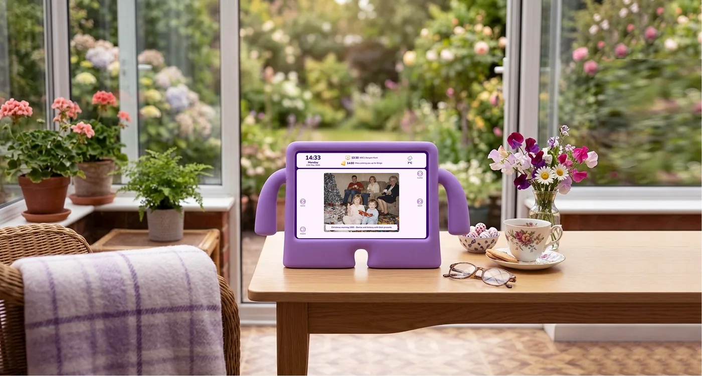 A nellie tablet showing a family photo slideshow in a sunny conservatory