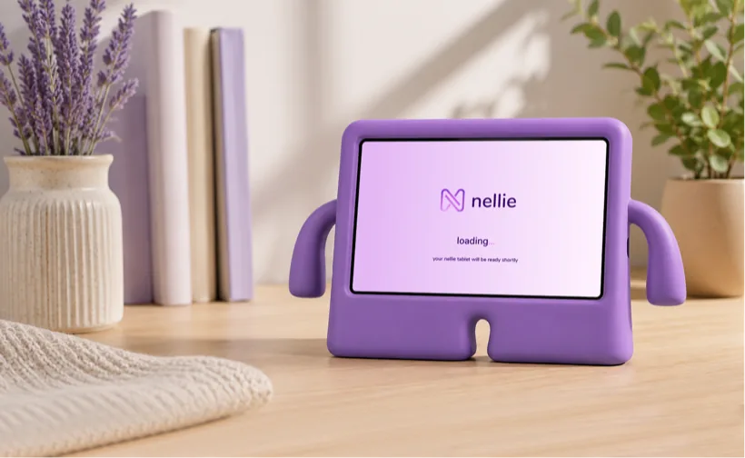 The nellie tablet in its purple easy-hold case on a desk